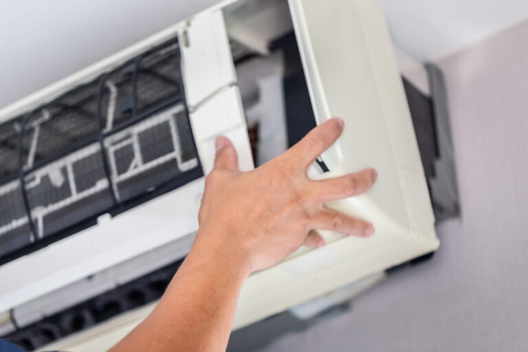 Repairman fixing modern air conditioner, Male technician cleanin